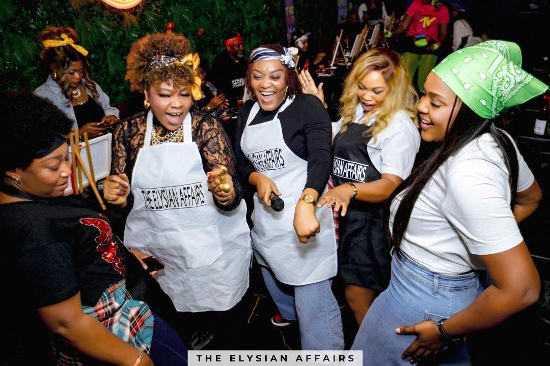 Group of women joyfully dancing at The Elysian Affairs event.