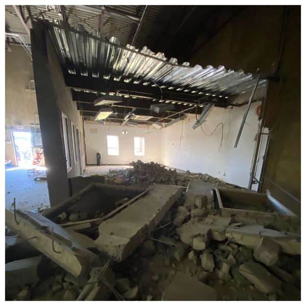 Cement concrete masonry walls structured with rebar in a commercial warehouse space demolished.