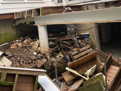 Large amount of demolition debris that is being hauled away by local debris and junk removal team.