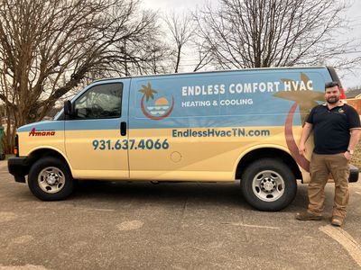 Endless Comfort HVAC service van in Middle Tn. parked outdoors with a technician standing beside it.