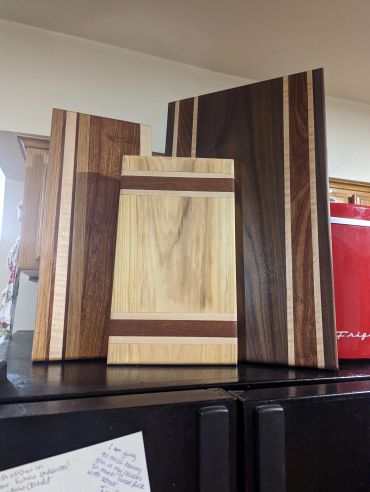 Three wooden cutting boards with different stripe patterns.