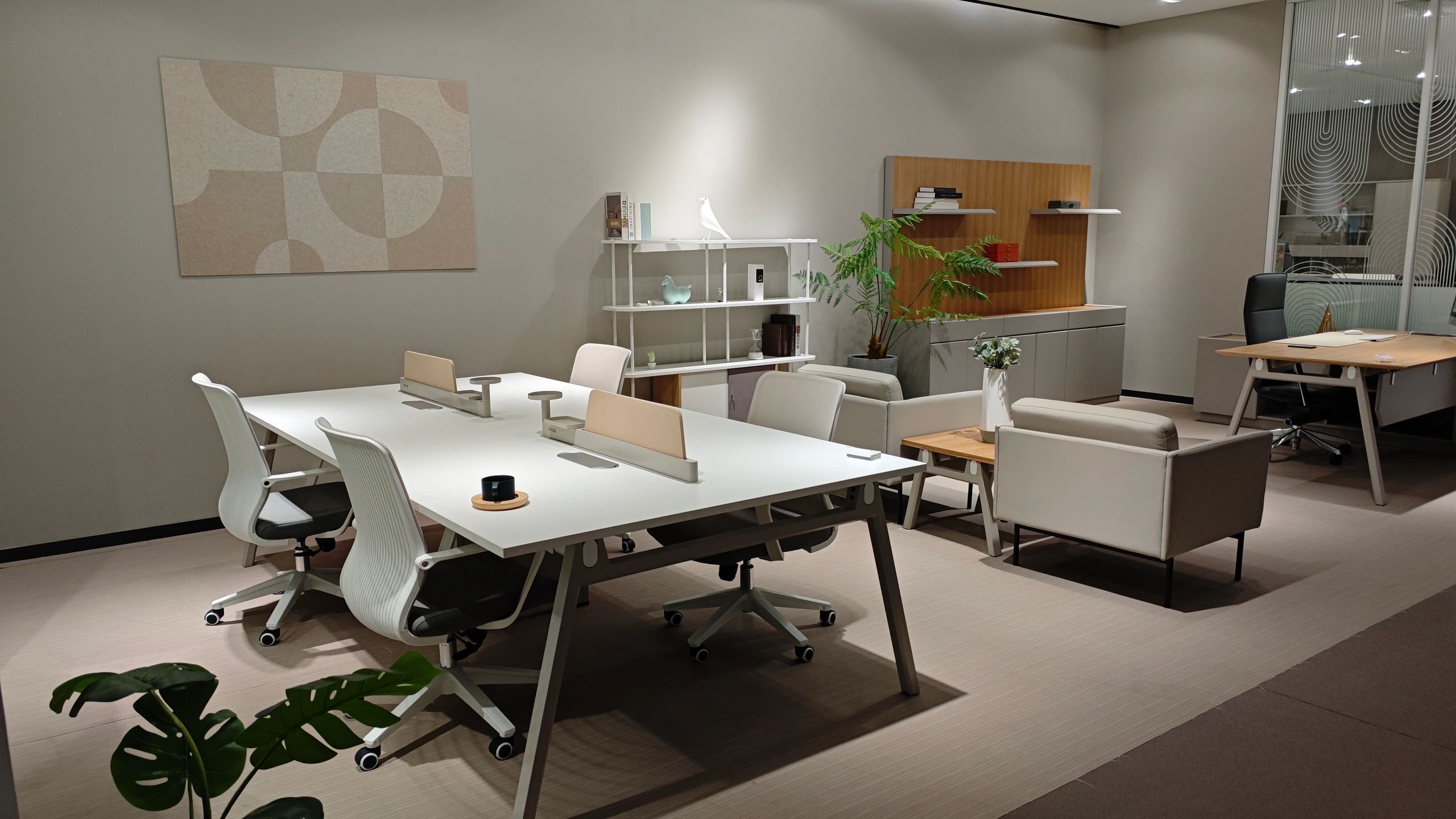 Modern office space with white desks and chairs.