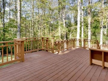 New wood deck construction with railing. Stained and treated to preserve longevity. 