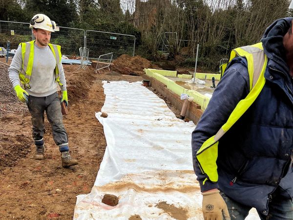 Workers on the construction site checking the ground