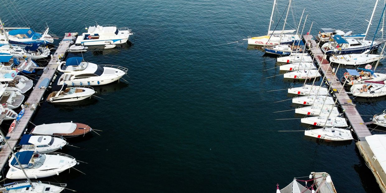 Aerial view of boats docked at a marina with calm water.