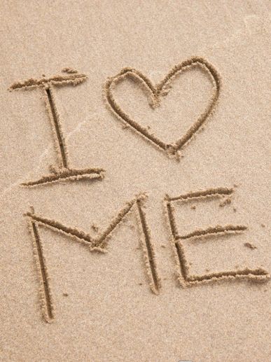 Message 'I love me' written in sand with a heart symbol.