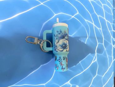 Blue floral keychain with transparent background.