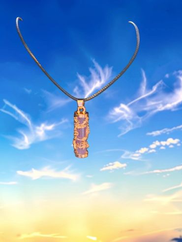 A pendant necklace floating against a blue sky.