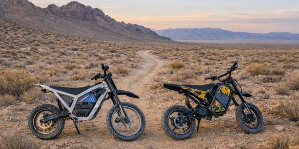 Two off-road electric bikes in a desert landscape.
