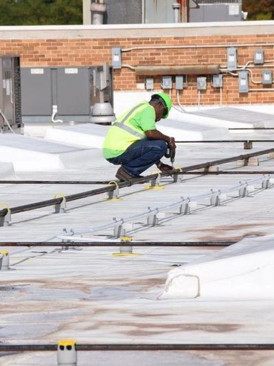 Contractor working on Roof Top Supports