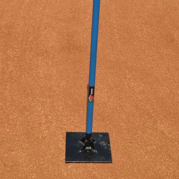 A blue-handled tool with a flat metal base on a reddish dirt surface.