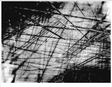 Abstract black and white image with intersecting lines and shadows.