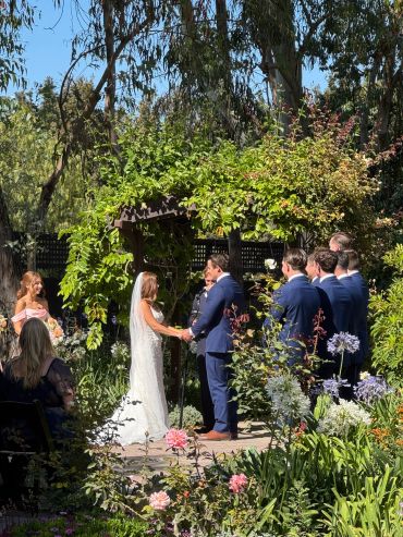 Couple exchanging vows in a garden wedding ceremony.