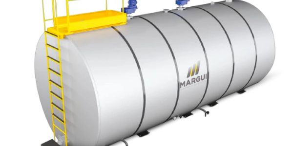 Large industrial metal storage tank with yellow ladder and platform.