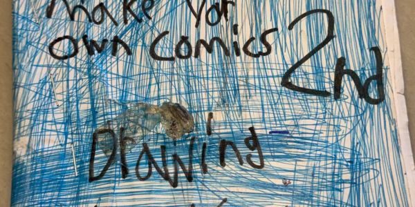 Hand-drawn comic cover with blue scribbles and text about making comics and drawing.