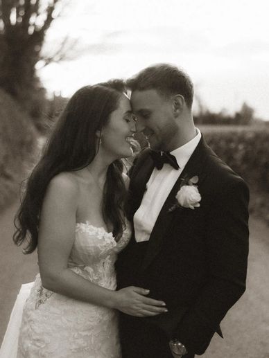 A bride and groom share a tender moment on their wedding day.