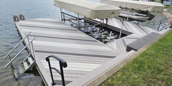 Wooden dock with metal railings on a lake.