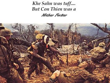 Soldiers carrying a wounded comrade through rough terrain during wartime.