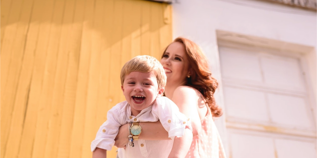 Mom holding her child while they play