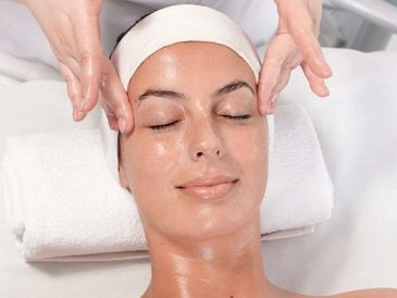 Woman relaxed and receiving a facial