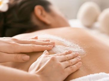 Woman receiving a back facial.