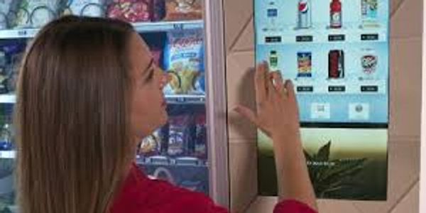 Woman making selection at a vending machine