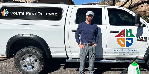 Colts Pest Defense Owner, Colton Hays in front of home ready to perform pest treatment
