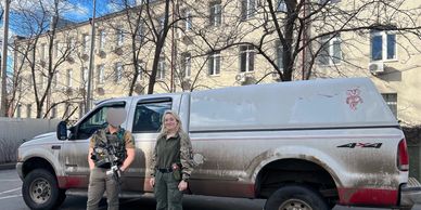 Ukrainian soldier and volunteer next to  combat vehicle