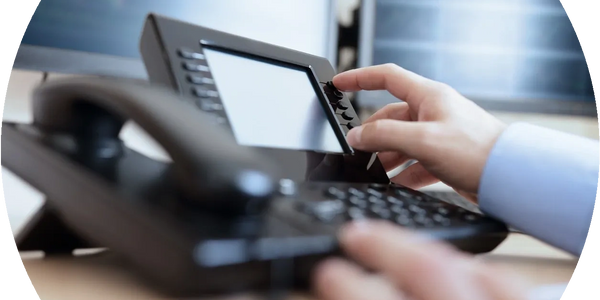 Someone using a desk telephone.