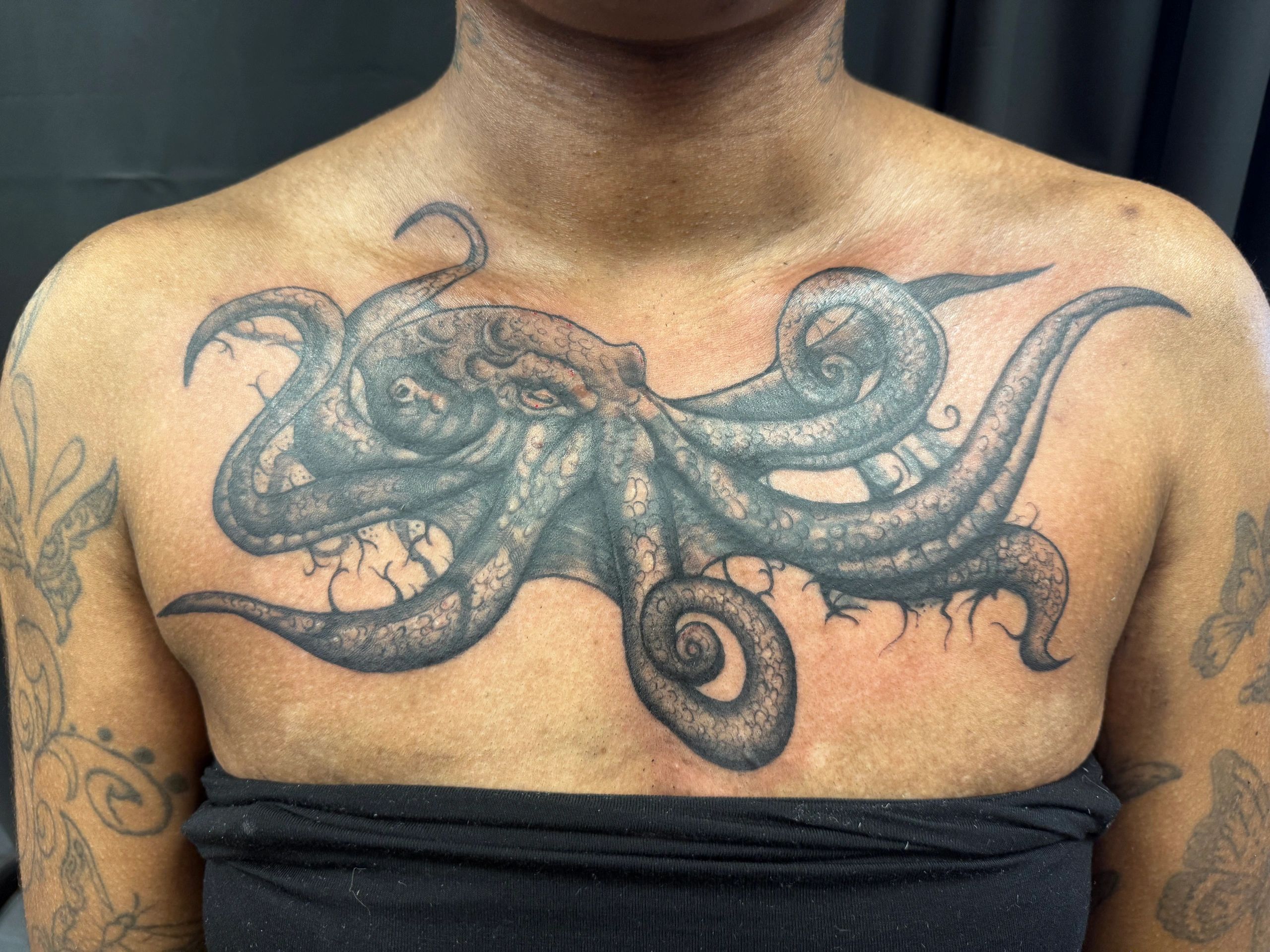 Intricate octopus tattoo on the chest.