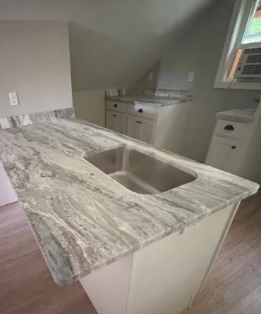 Marble countertop with sink in kitchen.