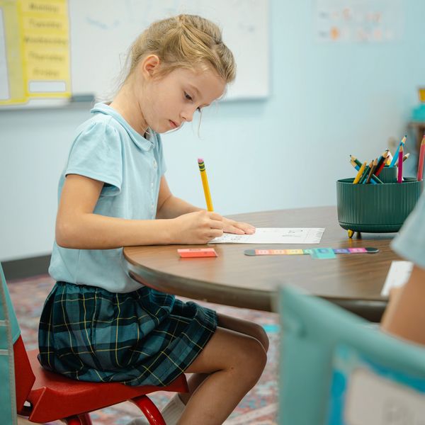 Female student working at desk.