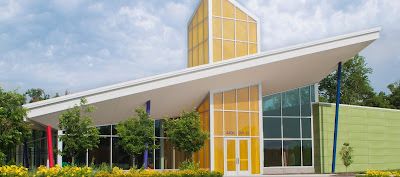 Modern building with colorful geometric design and sloped roof.