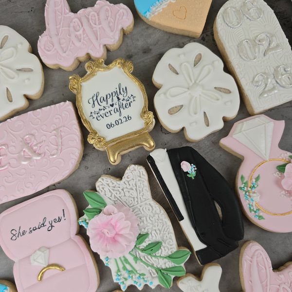 Wedding-themed decorated cookies with bride, groom, and romantic messages.