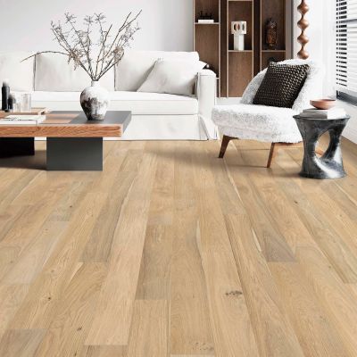 Modern living room with light wood flooring and cozy furniture.
