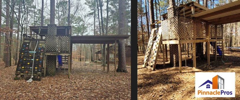 Wooden playground structure with climbing walls in a wooded area.