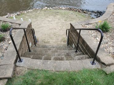 Stone steps leading down to a riverbank.