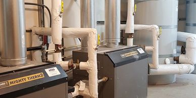Industrial heating system with insulated pipes and Mighty Therm2 units.