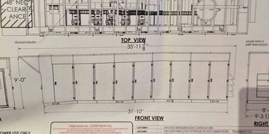 Technical drawing showing front and top views of a rectangular structure with multiple sections.