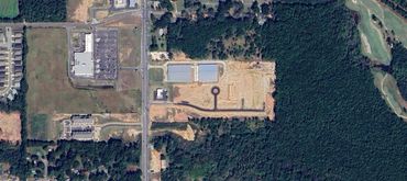 Aerial view of buildings and forest.