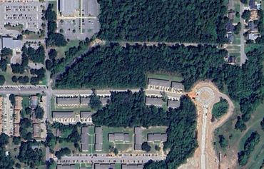 Aerial view of a residential area with surrounding greenery.