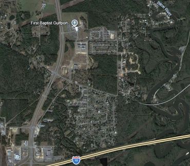 Aerial view of a town near a highway and a river.