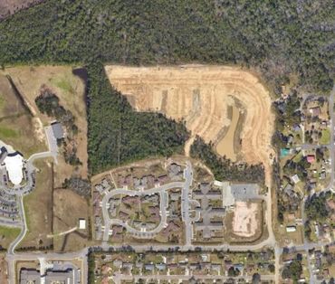 Aerial view of a suburban neighborhood and construction site.