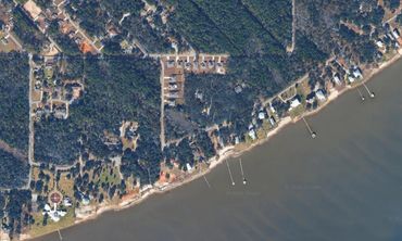Aerial view of a coastal residential area with docks.