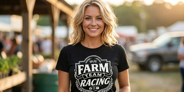 Smiling woman wearing a black Farm Team Racing t-shirt outdoors.