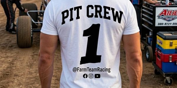 Man wearing a white PIT CREW shirt with number 1 at a racing pit stop.