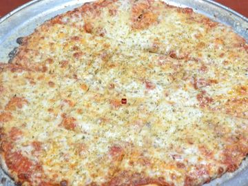 Cheese pizza with herbs baked on a tray.