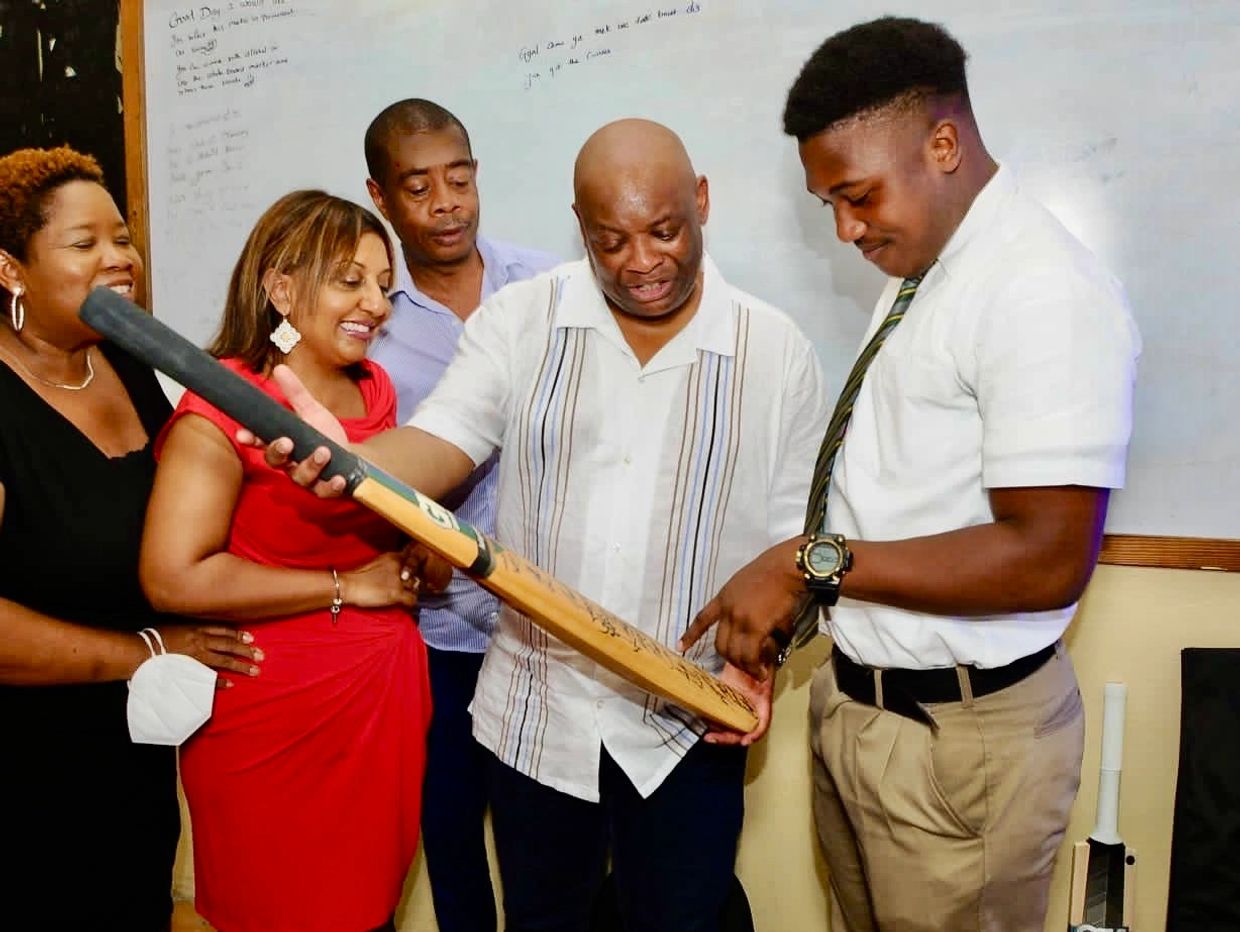 SET Foundation presents Excelsior High school Captain Brandon English (right) with a West Indies aut