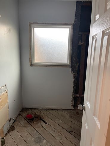 Empty room with wooden floor and window.