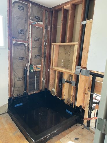 Custom shower pan built with hot mop, include hot & cold waterlines , new shower drain. Large niche.